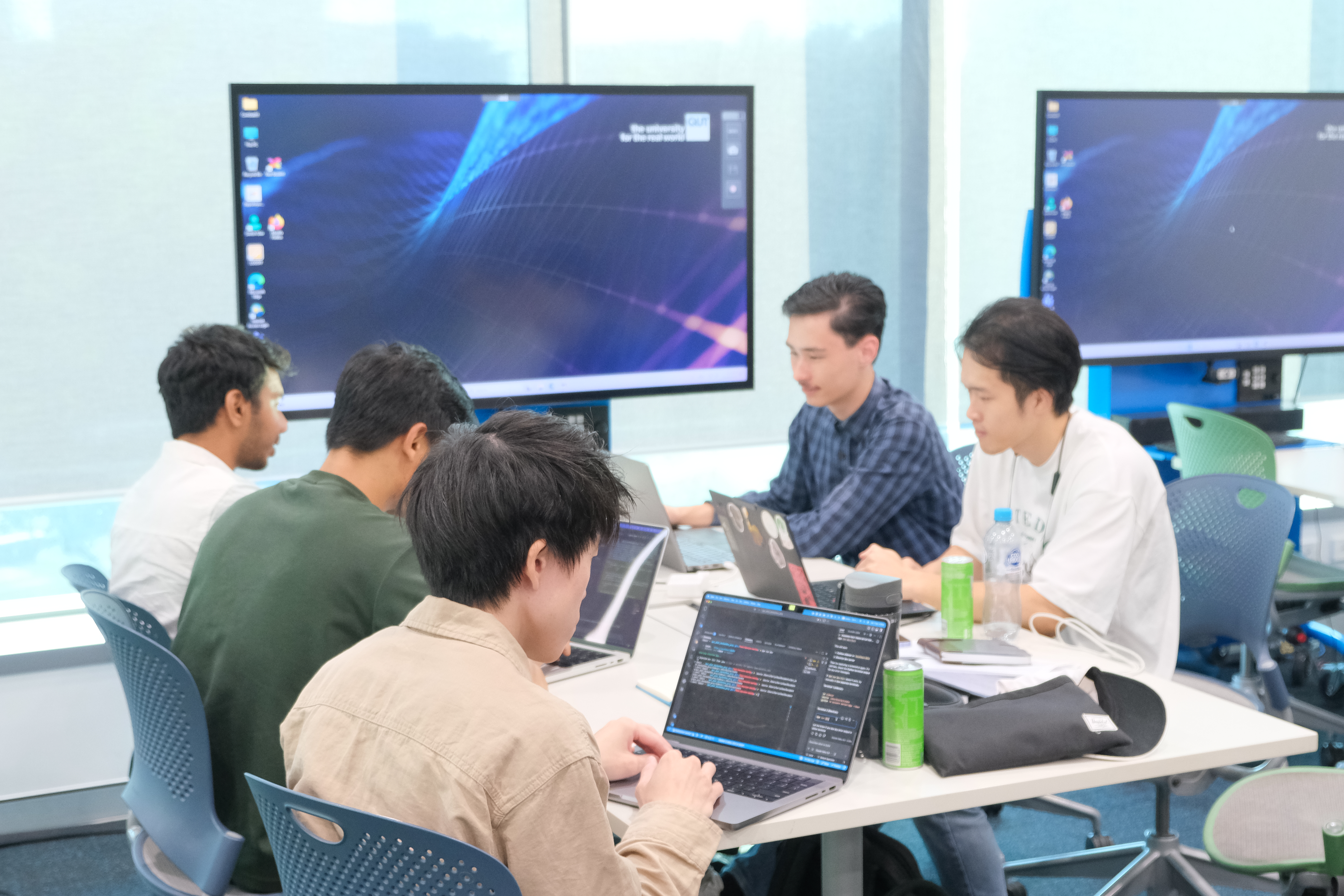 AIML Hackathon team collaborating around a laptop